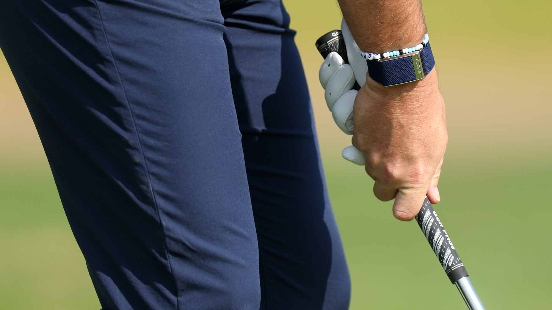 person grips golf club