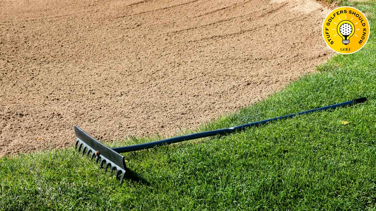A rake left on the edge of a bunker