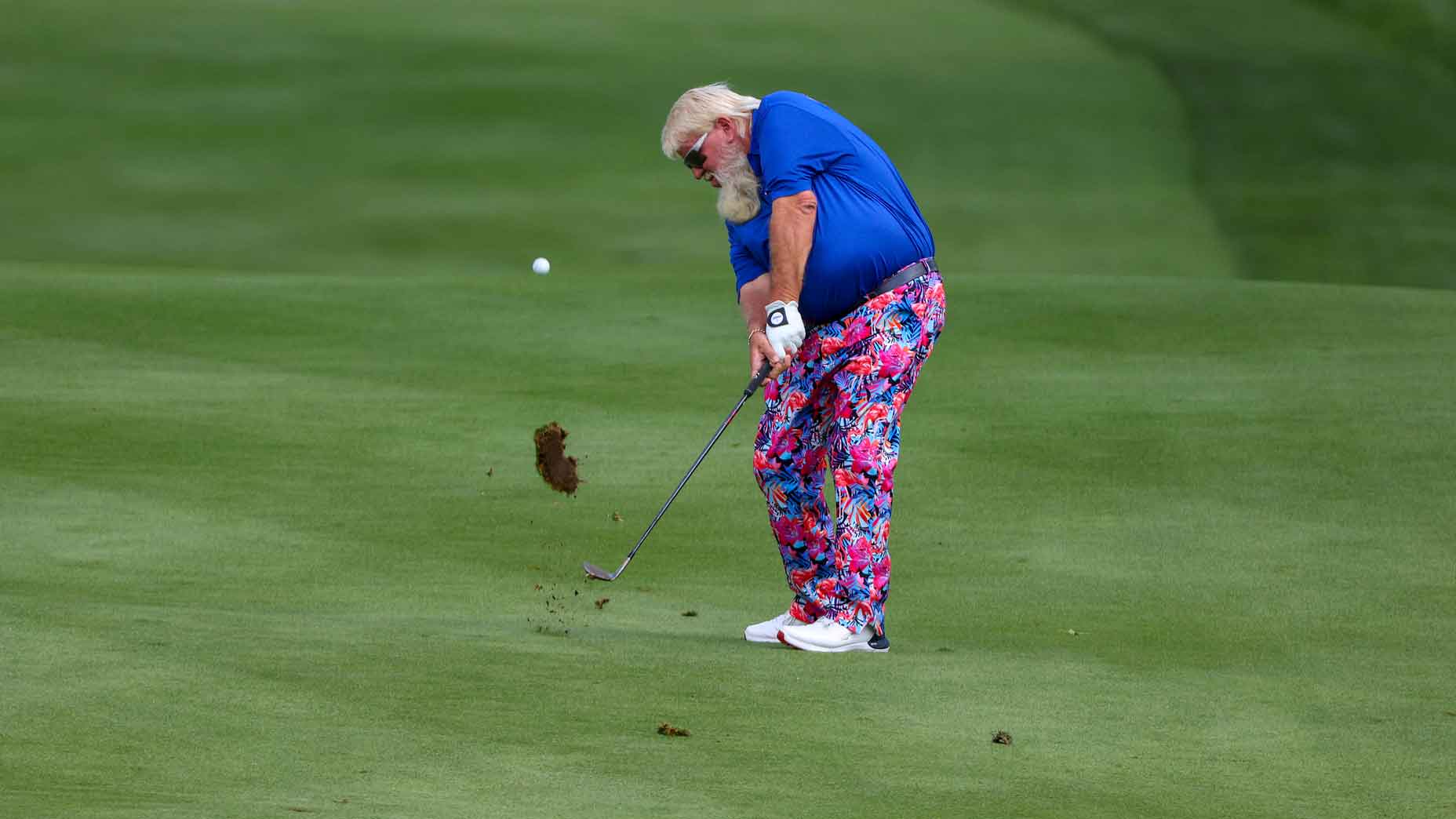 john daly hits approach shot during champions tour event