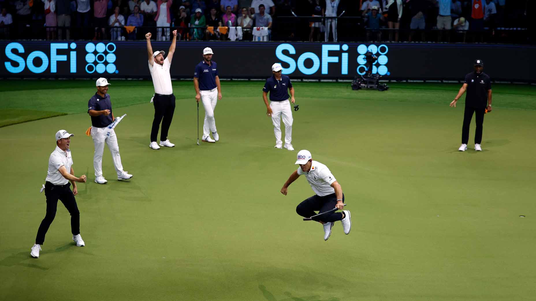 Billy Horschel, Justin Thomas and Patrick Cantlay celebrate a made putt during the TGL Finals.