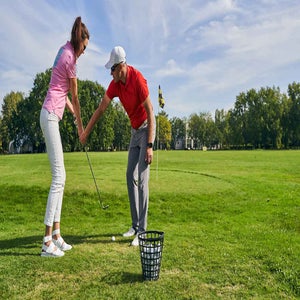 golf teacher gives pointers to student