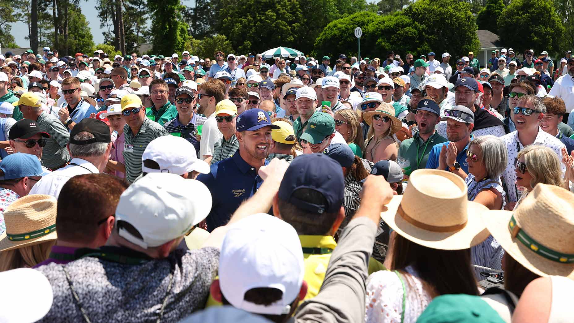 Bryson DeChambeau walks to a tee on Sunday at the Masters.