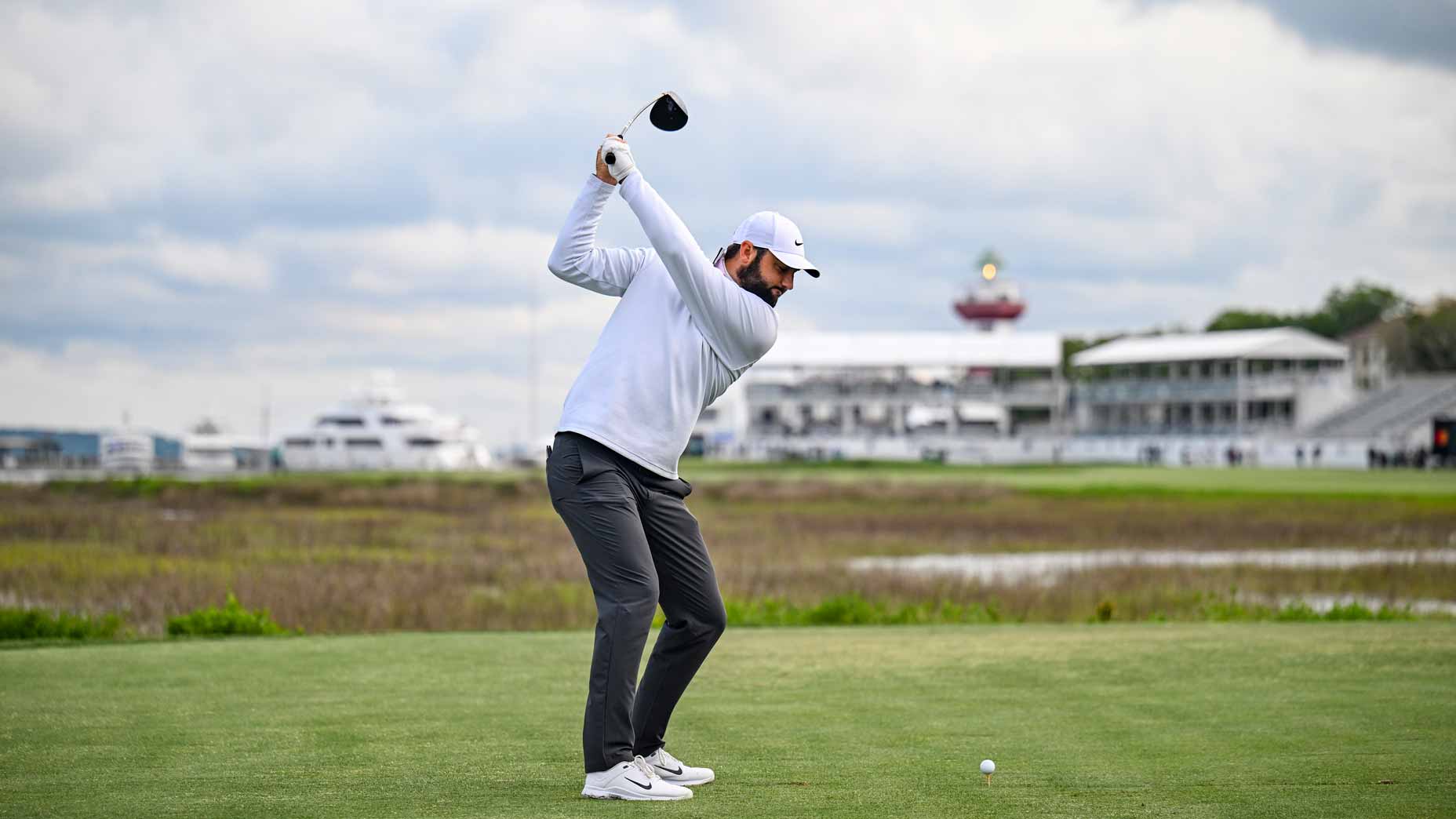 2025 RBC Heritage odds betting favorite Scottie Scheffler at the top of his swing as he plays his shot from the 18th hole tee with the lighthouse visible in the distance during the continuation of the final round of the RBC Heritage at Harbour Town Golf Links.