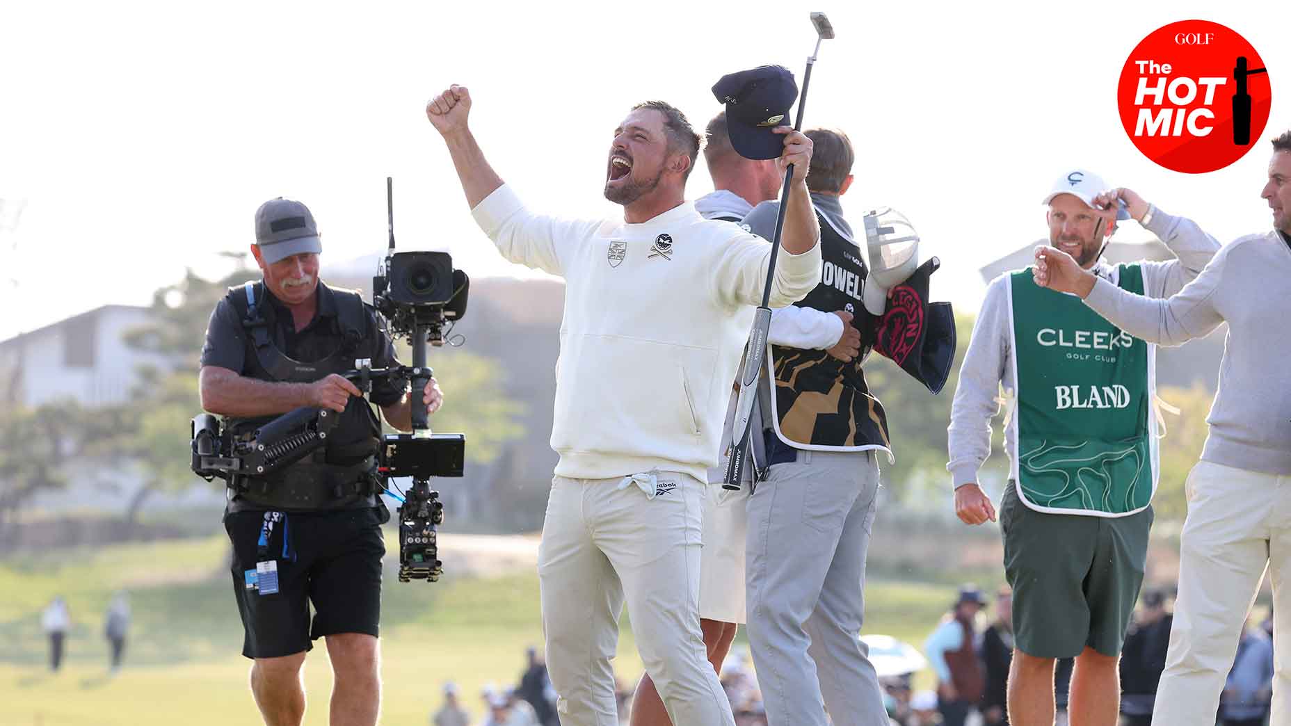 bryson dechambeau celebrates with putter over his head while tv cameras watch at LIV Korea