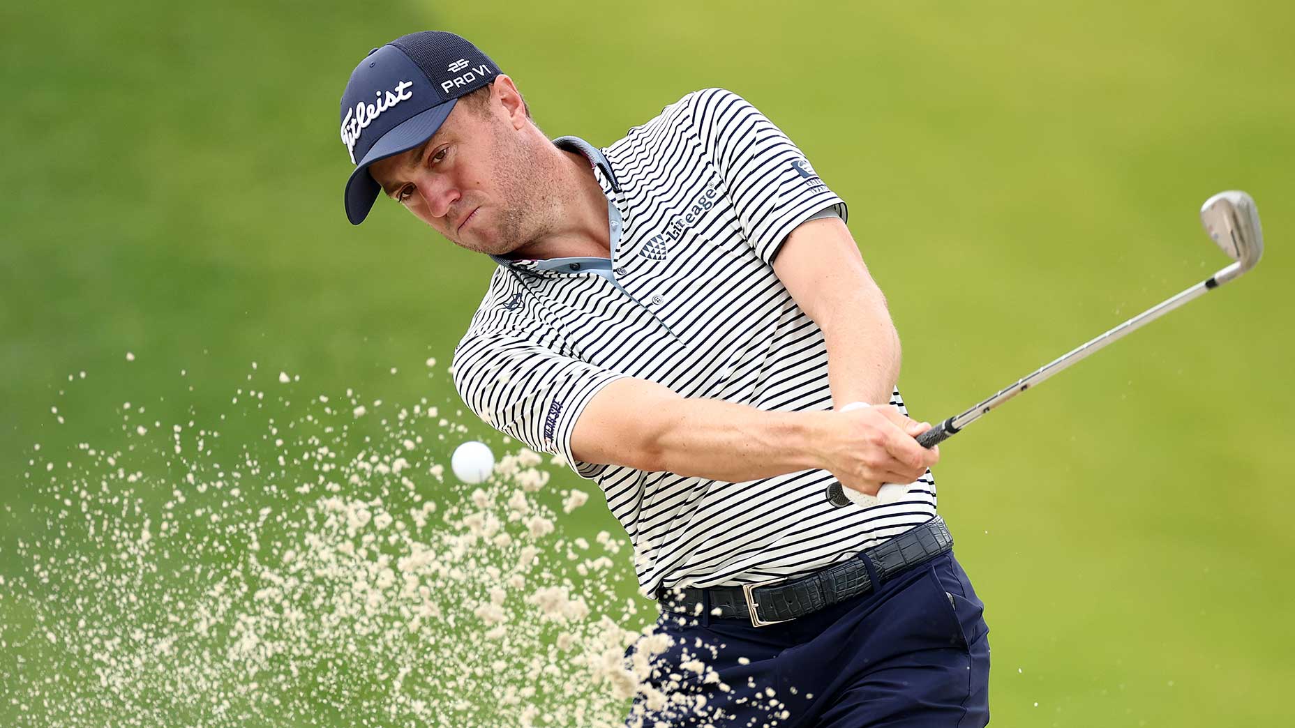 justin thomas hits out of a bunker during a pga championship practice round