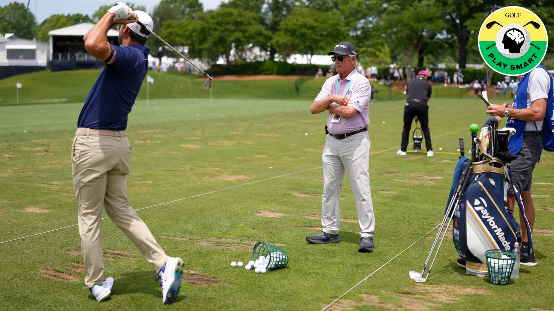 scottie scheffler hits balls on the range at the 2025 pga championship while randy smith watches