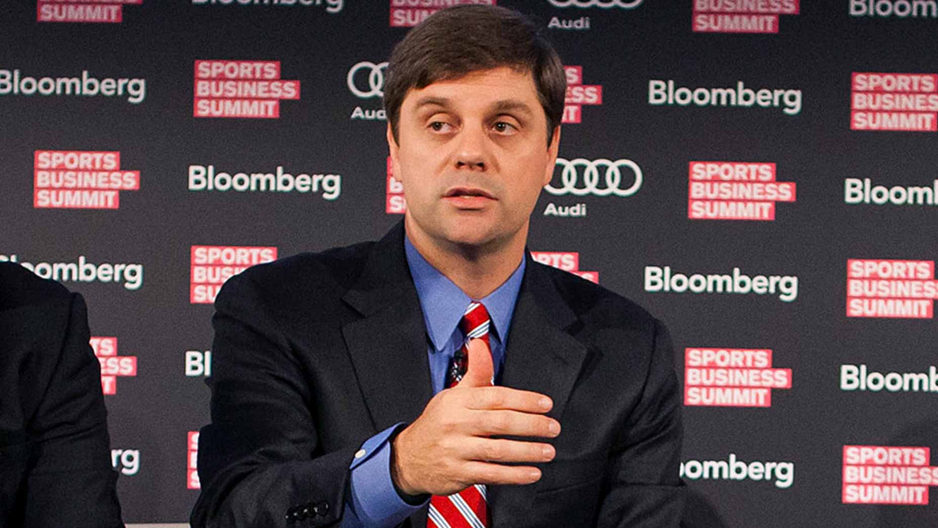 The NFL's brian rolapp speaks at a press conference held by bloomberg in a suit and tie