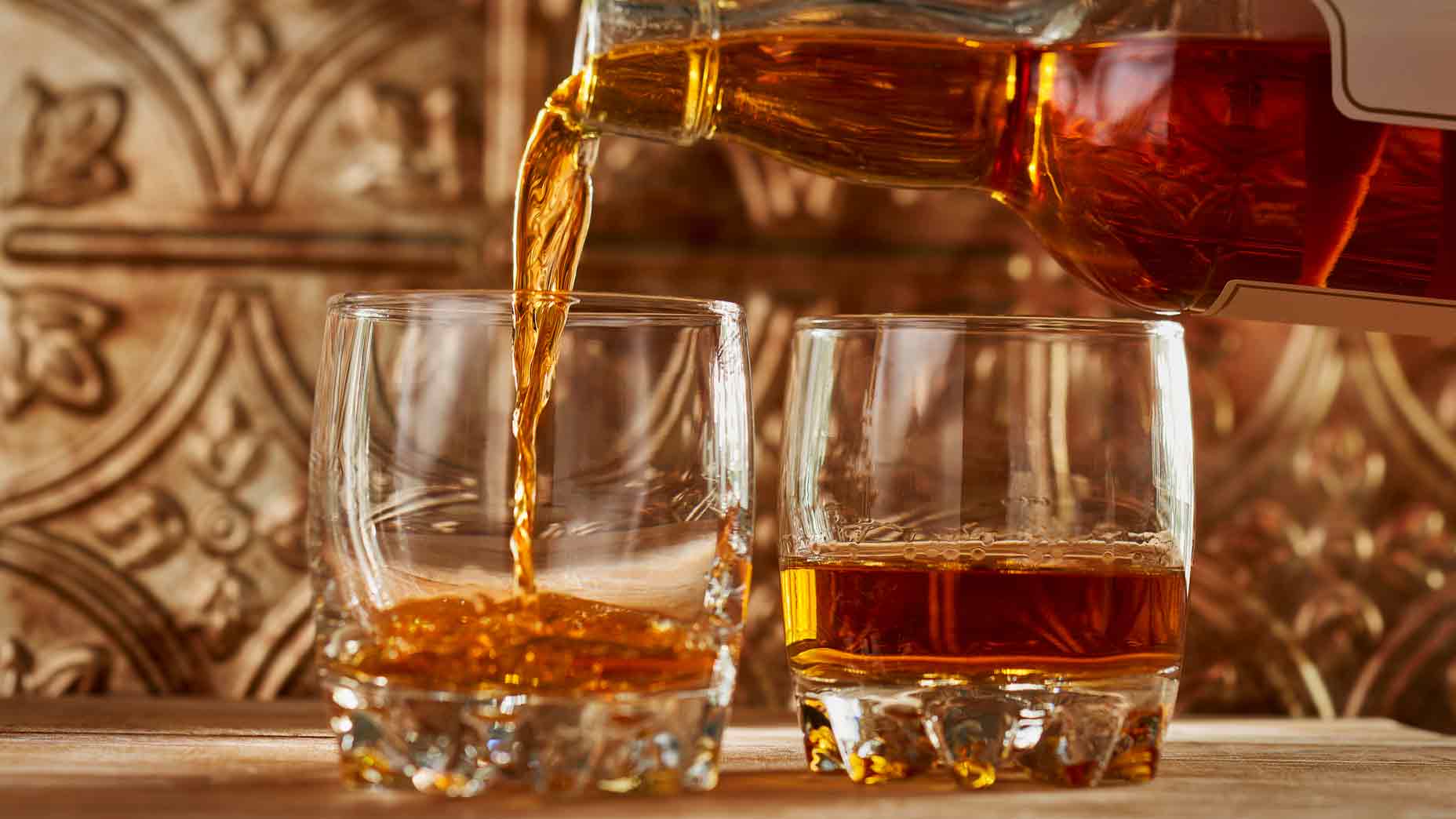 whisky being poured into glasses
