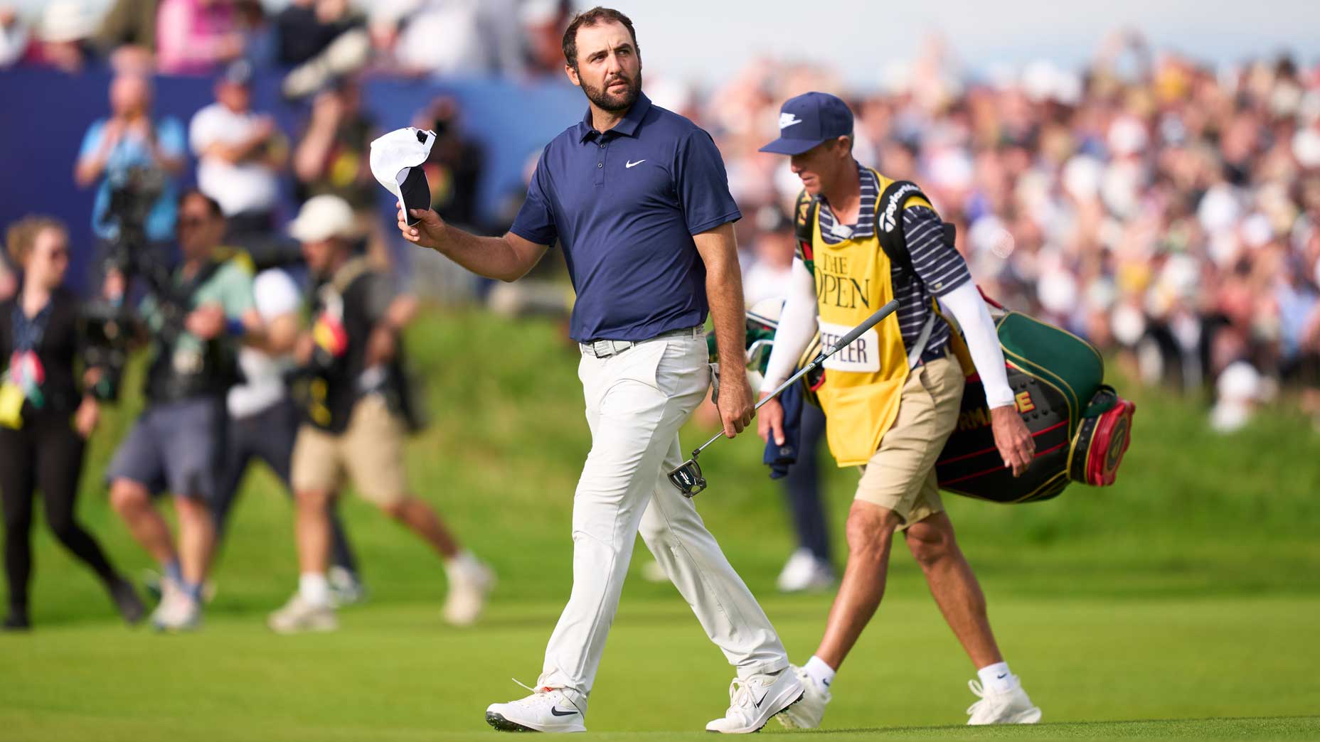 Scottie Scheffler of United States acknowledges the crowd on the 18th hole during day four of The 153rd Open Championship at Royal Portrush Golf Club on July 20, 2025 in Portrush, Northern Ireland.