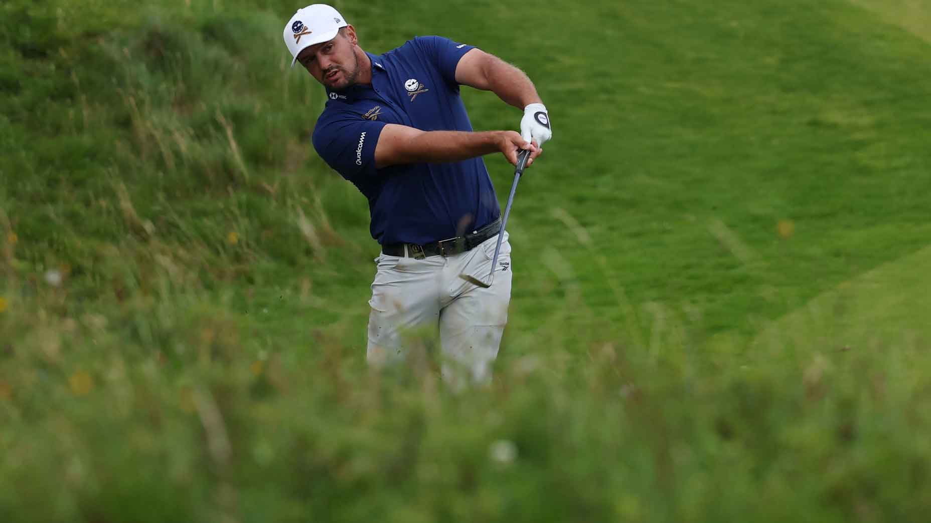 bryson dechambeau hits a ball from the tall rough during the first round of the 2025 open championship