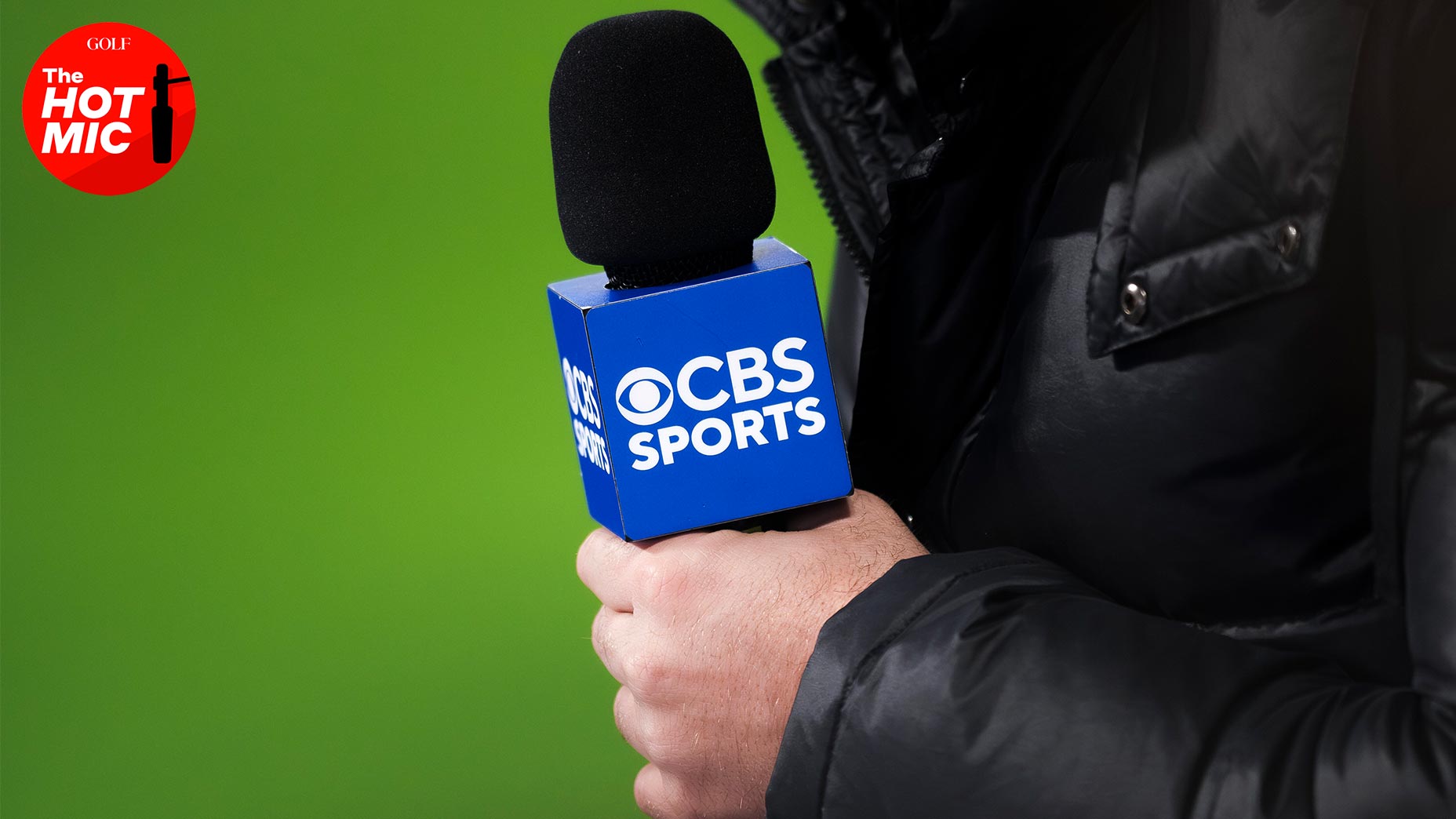 a sideline reporter holds a cbs sports microphone