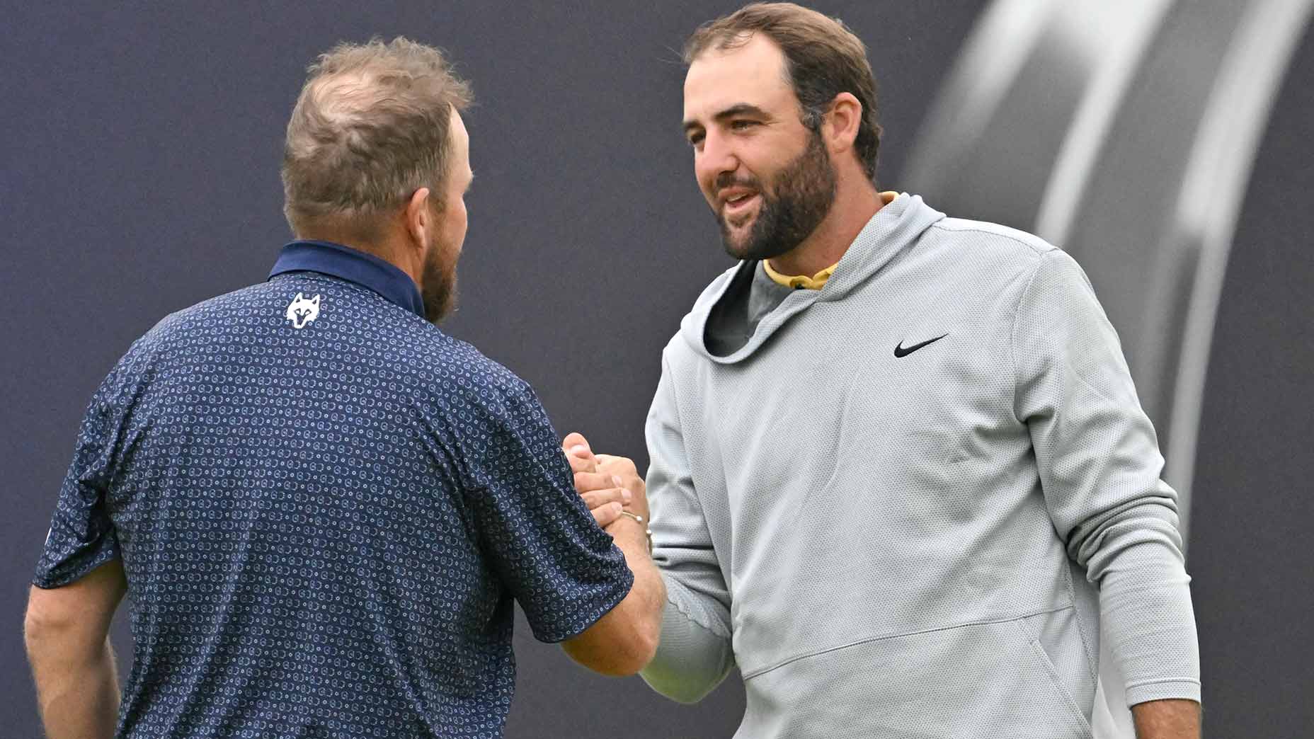 Scottie Scheffler and Shane Lowry shake hands following the second round of the 2025 Open Championship.