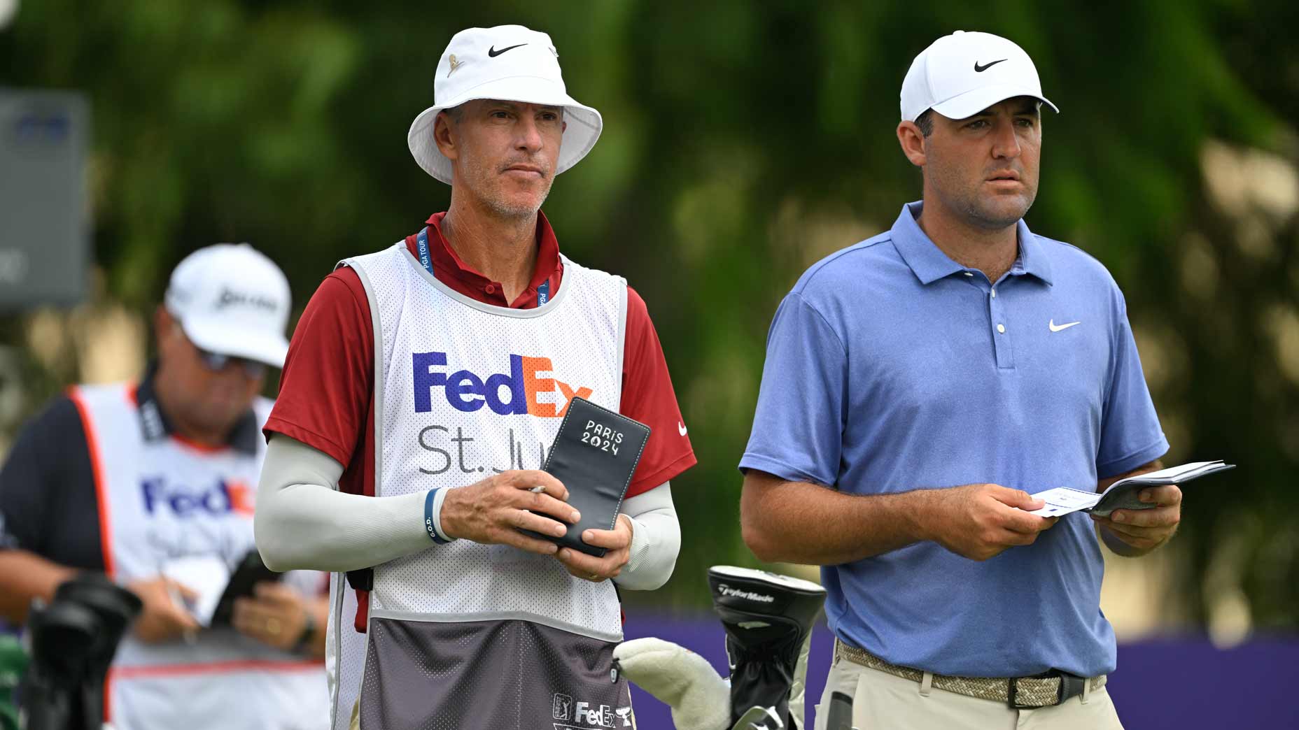 Scottie Scheffler stands with his caddie, Ted Scott, on the 12th tee box during the second round of FedEx St. Jude Championship at TPC Southwind on August 8, 2025 in Memphis, Tennessee.
