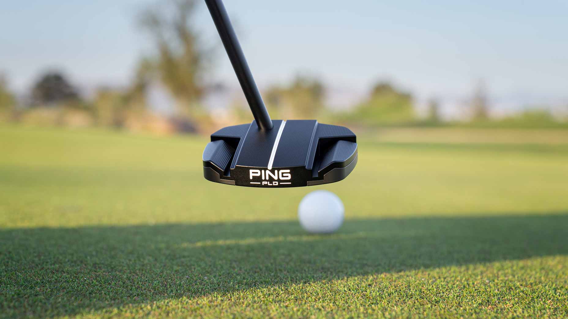 Ping Ally Blue SE Onset putter hits golf ball on golf course