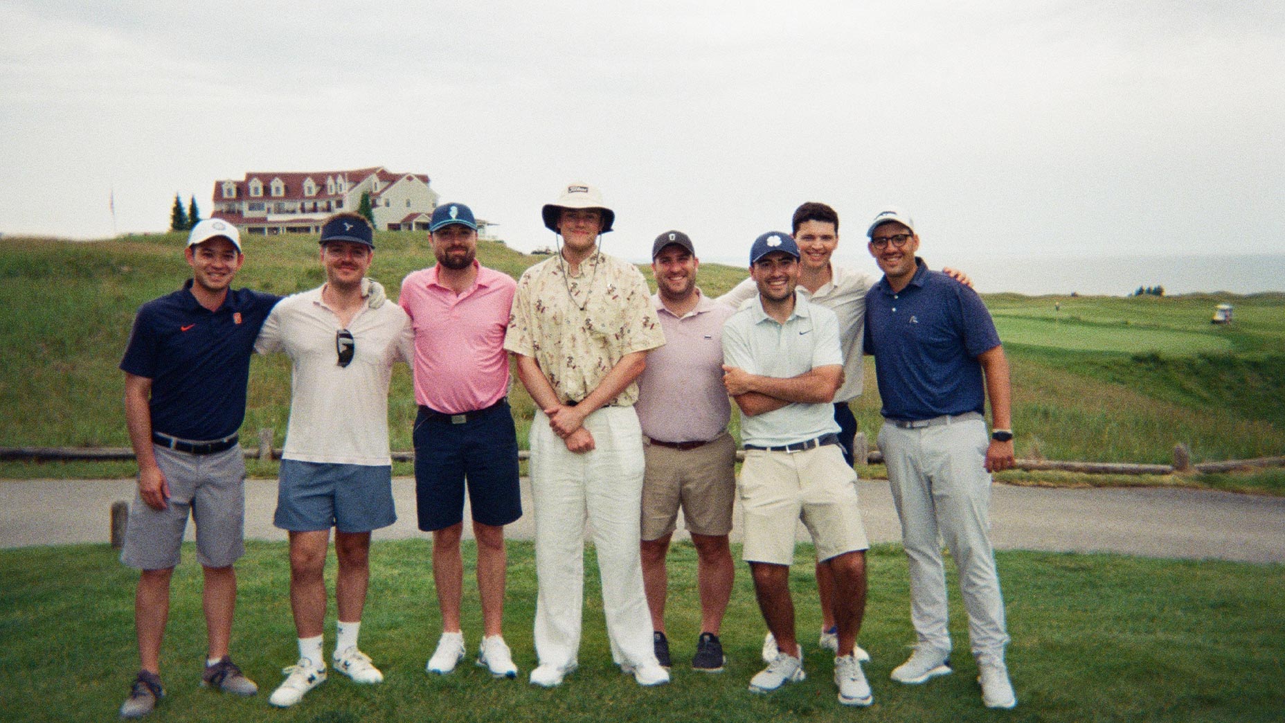 the author poses with friends on a golf course