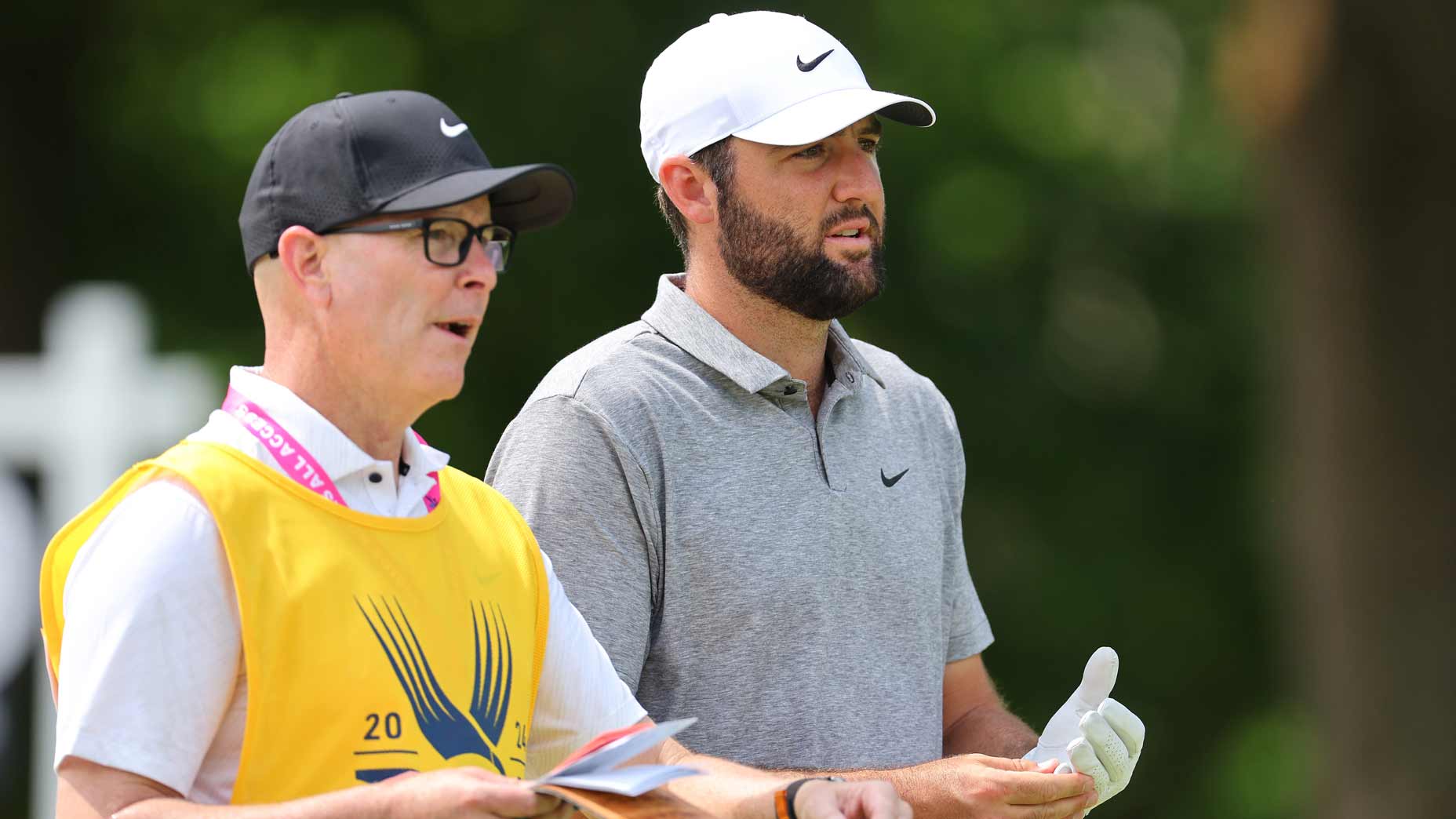 Scottie Scheffler of the United States and caddie Brad Payne prepare to play a shot from the eighth tee during the third round of the 2024 PGA Championship at Valhalla Golf Club on May 18, 2024 in Louisville, Kentucky. (
