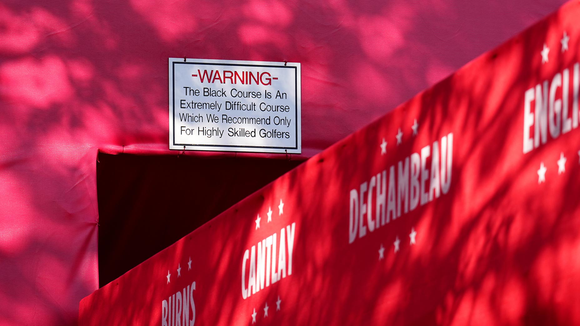 the bethpage black sign sits above the entrance to the Ryder Cup first tee at Bethpage Black