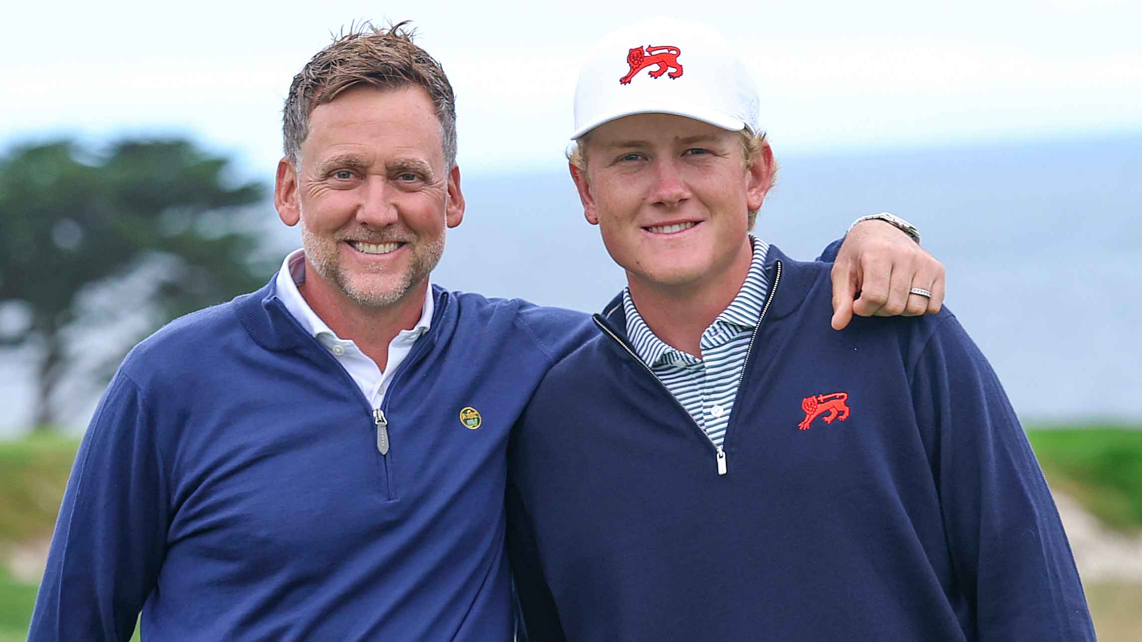 Ian Poulter poses with his son, Luke Poulter of Team Great Britain and Ireland, on the 16th hole during a practice round ahead of The 50th Walker Cup