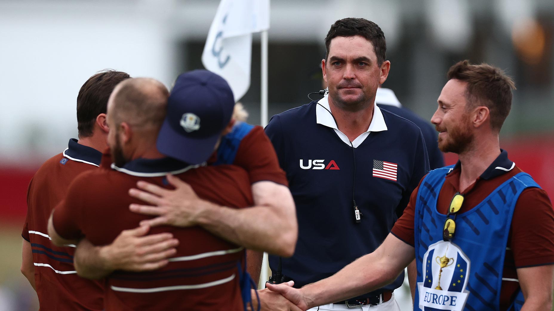 Captain Keegan Bradley of Team United States looks on after Matt Fitzpatrick and Tyrrell Hatton of Team Europe react