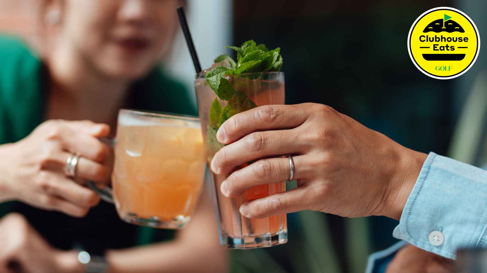 Two friends making a celebratory toast with mocktails, sitting at outdoor bar. Friends celebration. Romantic dating
