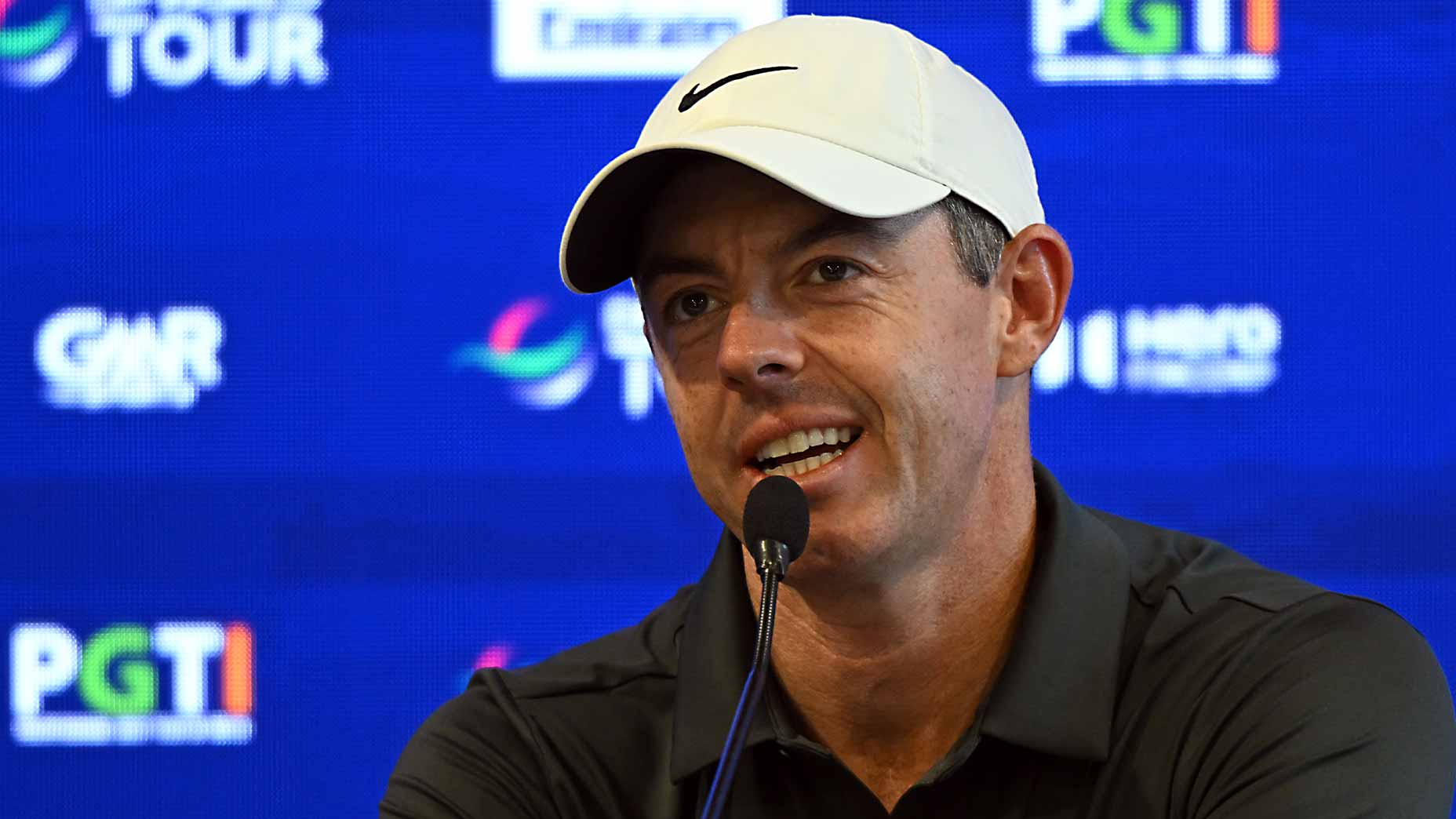 rory mcilroy speaks at dp world tour event in india at press conference in white hat