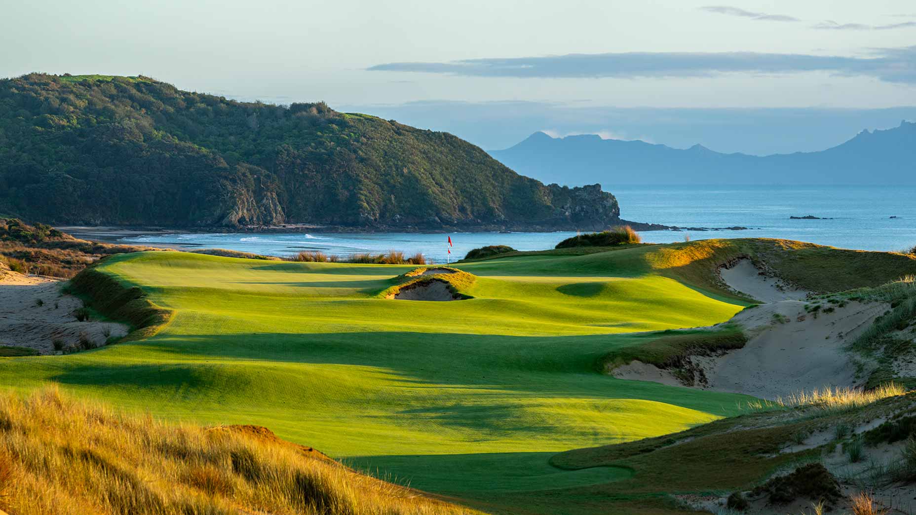 a stunning cliffside view of the 14th on the south course at te arai in new zealand
