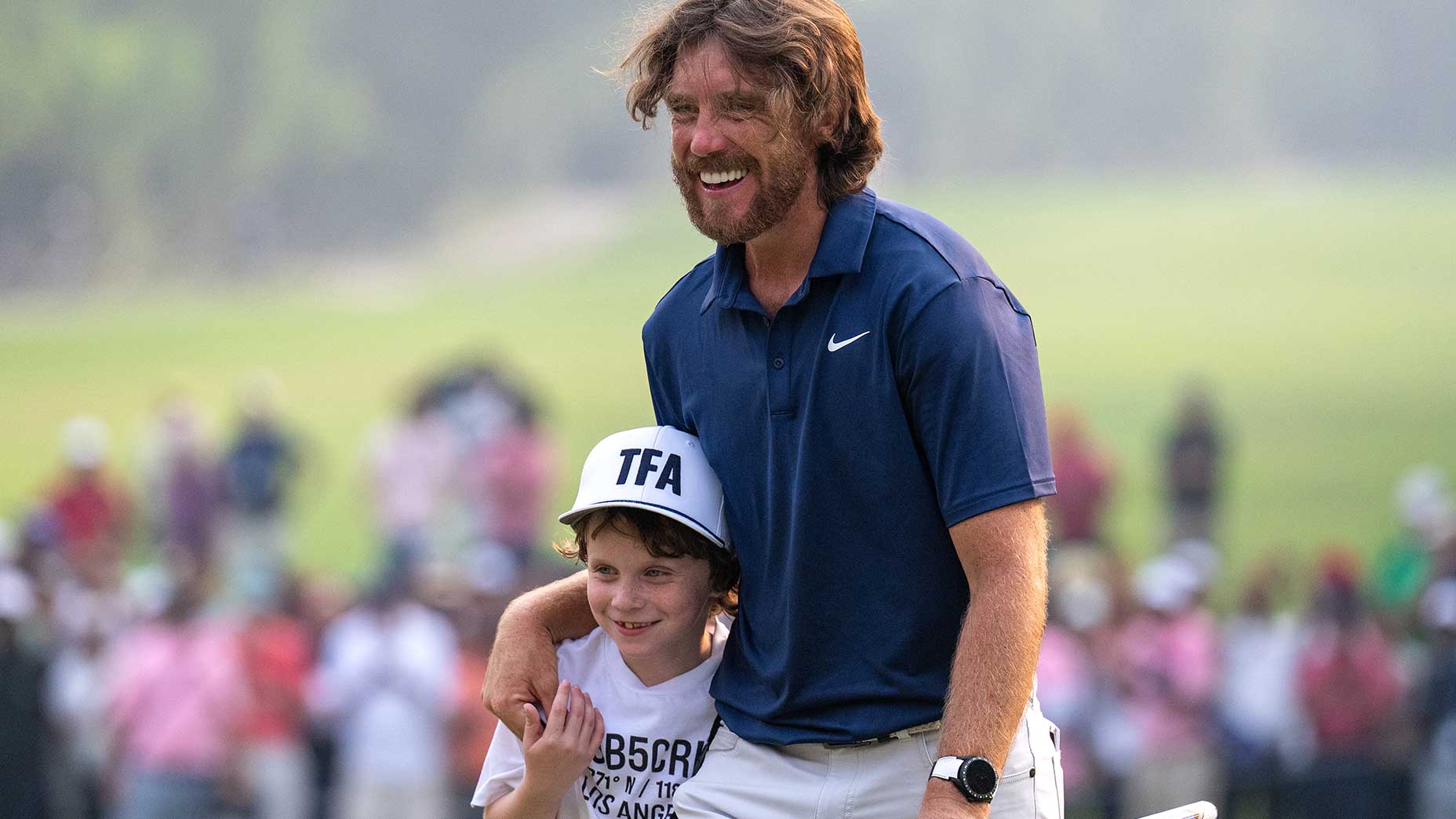 Tommy Fleetwood celebrates with his son, Frankie, after winning the DP World India Championship on Sunday in New Delhi, India.