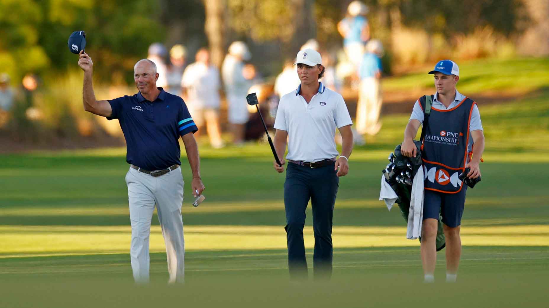 Cameron Kuchar and Matt Kuchar walk up the 18th hole during the first round of the PNC Championship 2025 at Ritz-Carlton Golf Club on December 20, 2025 in Orlando, Florida. (Photo by Mike Ehrmann/Getty Images)