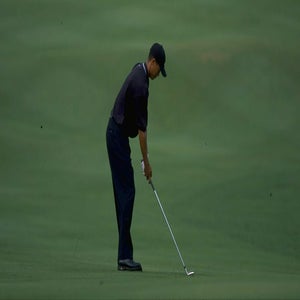 tiger woods sets up to hit golf ball at the 2000 johnnie walker classic