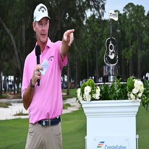 Tommy Gainey ppints with trophy after winning the 2025 Constellation FURYK & FRIENDS tournament.